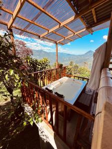 a porch with a hot tub on a deck at Titiribi-Antioquia- Cabaña el sol in Titiribí