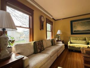 a living room with a couch and a window at This Old Frat House Boutique Guest in Missoula