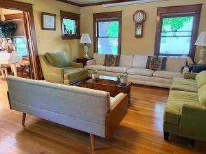 a living room with a couch and chairs and a table at This Old Frat House Boutique Guest in Missoula