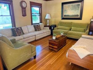 a living room with two couches and a coffee table at This Old Frat House Boutique Guest in Missoula +38 photos