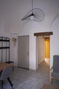 a living room with a table and a fan at Les Vans Centre-village in Les Vans