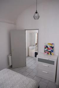 a white room with a refrigerator and a sink at Les Vans Centre-village in Les Vans +2 photos
