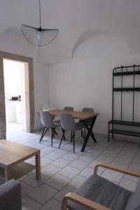 a living room with a wooden table and chairs at Les Vans Centre-village in Les Vans