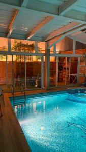 a swimming pool in a building with a large pool at Nouira Haus in Akouda