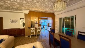 a living room and kitchen with a chandelier at Nouira Haus in Akouda +25 photos