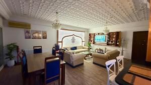 a living room with a couch and a dining room table at Nouira Haus in Akouda