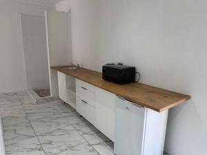 a kitchen with a counter with a black appliance on it at Veesboutiquehotel in eMalahleni