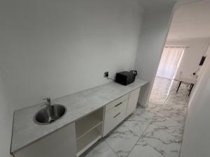 a bathroom with a sink and a counter at Veesboutiquehotel in eMalahleni
