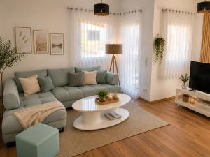 a living room with a couch and a table at Ena Appartements in Altenmarkt im Pongau