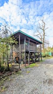 a large wooden house with a large deck at Molco Cabins Palafito in Pucón