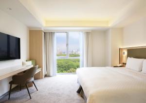 a hotel room with a bed and a large window at Dandy Hotel-Daan Park Branch in Taipei +67 photos