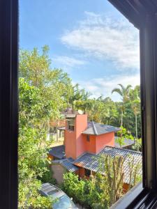 a view from a window of a house at Charme e conforto - surf pertinho de casa in Garopaba +41 photos
