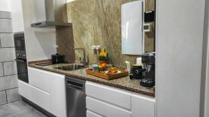 a kitchen with a sink and a counter top at El Pajar - Apartamento rural en la Vía Verde in Luque