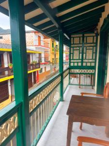 a porch with a bench and a view of a street at Hotel Barajas in Jardin
