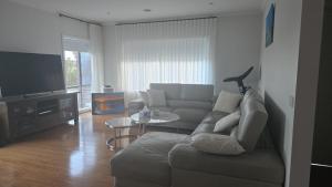 a living room with a couch and a table at Sunset in Pakenham in Pakenham