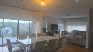 a dining room and living room with a table and chairs at Sunset in Pakenham in Pakenham