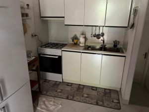 a small kitchen with a sink and a stove at Villa Clelia in Stintino +10 photos