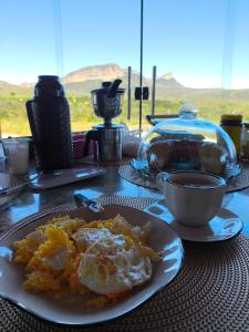 a table with a plate of food on a table at Chácara Sol e Lua dos três Morros in Piatã