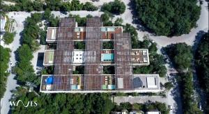 an aerial view of a building with solar panels at Amelia By Waves in Tulum