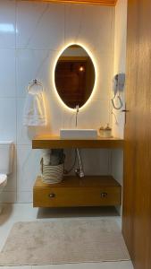 a bathroom with a sink and a mirror at Sítio Brisa da Serra Conforto e Tranquilidade in Lauro Müller +51 photos