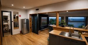a kitchen with a sink and a refrigerator at Panorama House in Bartolovci