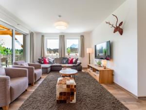a living room with a couch and a tv at Bergblick in Werfenweng