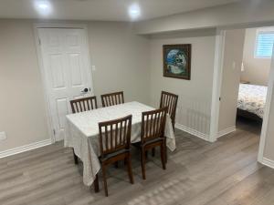 a dining room with a table and chairs and a bed at Newly Renovated 2BR Walkout Suite in the Heart of Kanata Ottawa in Ottawa