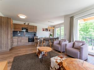 a kitchen and living room with a table and chairs at Bergblick in Werfenweng