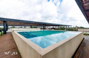 a swimming pool on the roof of a building at Amelia By Waves in Tulum