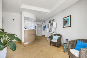 a waiting room with chairs and a counter in a room at Caloundra Affordable Beachside Studio in Caloundra
