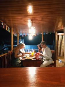 a group of people sitting at a table in a restaurant at Lombok Grace Bungalows in Tetebatu