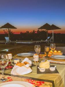 a table with plates of food and wine glasses at Agroturismo Xistos in Cerca