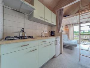 a kitchen with white cabinets and a stove top oven at Yellow Bird in Ellemeet
