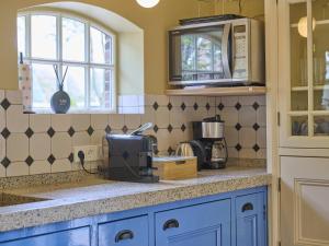 a kitchen with a counter top with a microwave at De Muldershof in Vriezenveen +87 photos