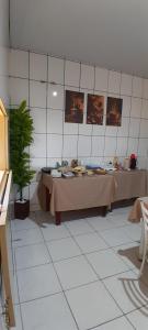 a room with a table with food on it at Hotel Reflexos in Santa Juliana