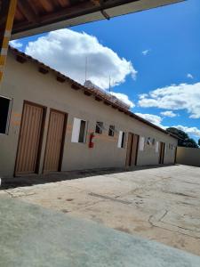 a building with doors on the side of it at Hotel Reflexos in Santa Juliana