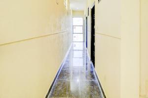 a corridor of an empty room with a tile floor at Hotel O Together in Bangalore