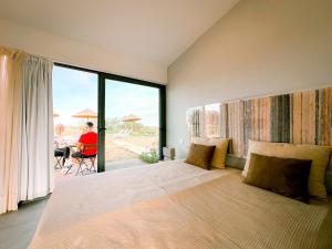 a bedroom with a large bed with a large window at Agroturismo Xistos in Cerca +43 photos