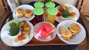 a table with plates of breakfast foods and drinks at Bausasran52 in Yogyakarta