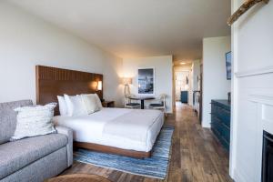 a hotel room with a bed and a couch at Manzanita Oceanfront Inn in Manzanita