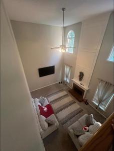 a living room with two couches and a tv at Stone Homes in Lawrenceville +3 photos