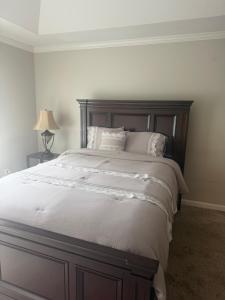 a bedroom with a large bed with white sheets and pillows at Stone Homes in Lawrenceville