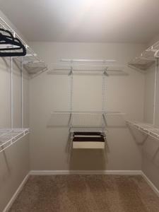 an empty room with shelves on the wall at Stone Homes in Lawrenceville