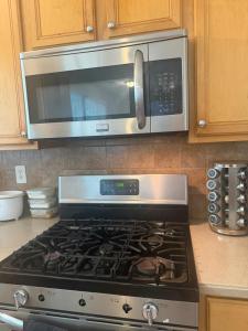 a microwave above a stove in a kitchen at Stone Homes in Lawrenceville