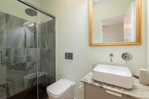 a bathroom with a shower and a toilet and a sink at Flores 21 Apartments Príncipe Real in Bicas