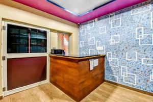 a bar in a room with a brick wall at OYO 80514 Moody Moon in Bārang