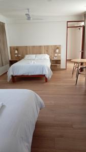 a bedroom with a bed and a table and a table at Hotel San Cosme in Camaná