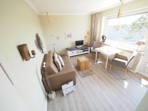 a living room with a couch and a table at Appartement-152 in Westerland