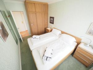 a bathroom with two white sinks in a room at Appartement-152 in Westerland