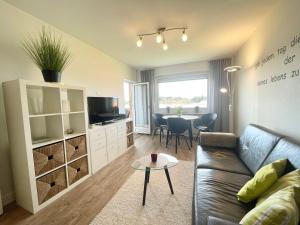 a living room with a couch and a table at Appartement-155 in Westerland
